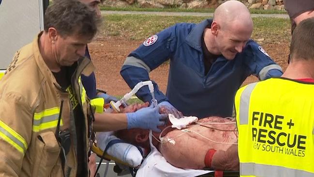 NSW Ambulance paramedics treated a man before taking him to hospital. Picture: TNV