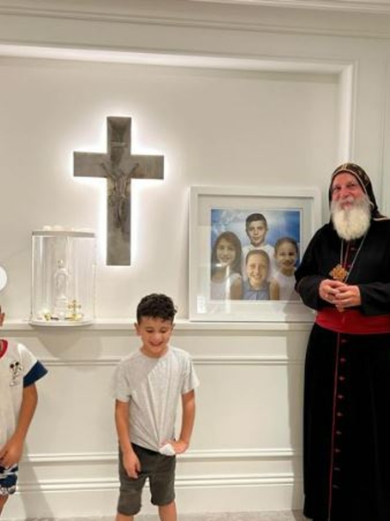 The bishop standing in front of a photo of the late Abdallah children. Picture: Instagram