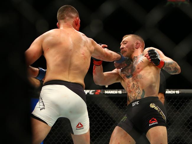 Nate Diaz (L) catches Conor McGregor with a right hand punch.