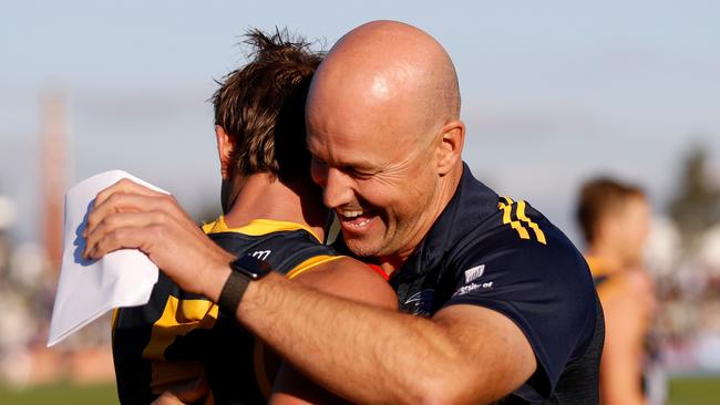 Matthew Nicks embraces Matt Crouch after a Crows game.