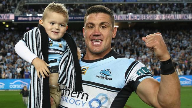 Chris Heighington celebrates with his son after the Sharks’ preliminary final win over the Cowboys.