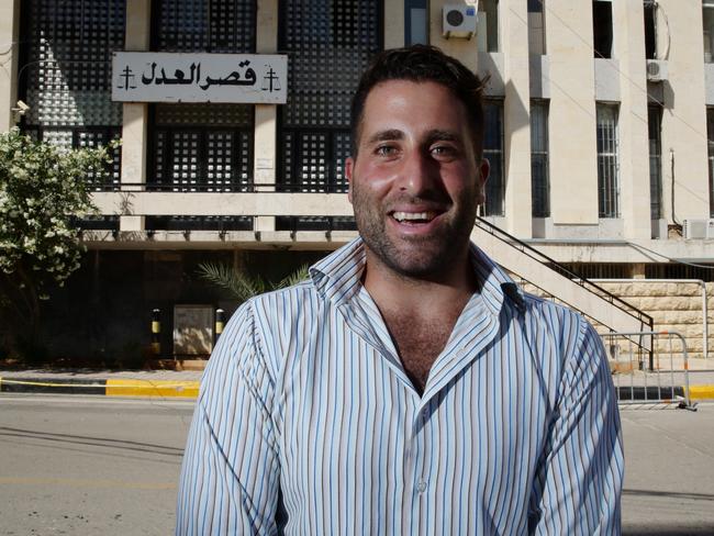 Ali Elamine laughing while posing for a photo after a deal was reached between all parties, outside the Palace of Justice, Baabda, Lebanon. Picture: Liam Kidston.