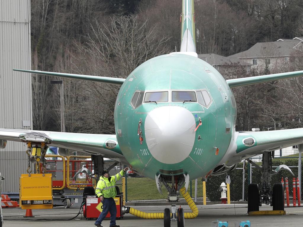 A worker stands near a Boeing 737 MAX 8 airplane parked at Boeing Co.'s Renton Assembly Plant in Renton, Washington on March 11. Picture: AP