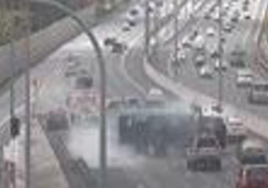 Traffic Camera Captures Moment of Truck Rollover on M1. Credit - Department of Transport and Main Roads Queensland via Storyful