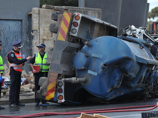 18/8/14 Serious crash invoving trucks and cars at the bottom of the freeway . People trapped in vehicles .  Police with he truck involved in the accident. Picture Roger Wyman