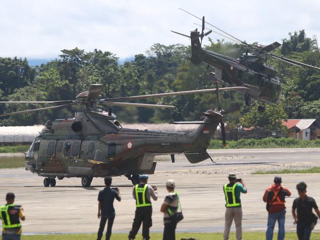 Indonesian Air Force helicopters take off as they evacuate the body of a New Zealand helicopter pilot at Mozes Kilangin Airport in Timika in Indonesia's Central Papua Province on August 6, 2024. Rebels in Indonesia's restive region of Papua shot dead a helicopter pilot from New Zealand, police said on August 5. (Photo by Sevianto PAKIDING / AFP)