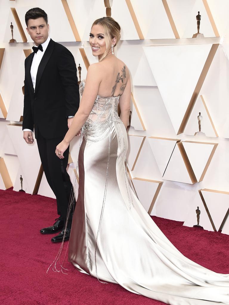 Colin Jost, left, waits for Scarlett Johansson and the rest of her dress to catch up on the red carpet. Picture: AP