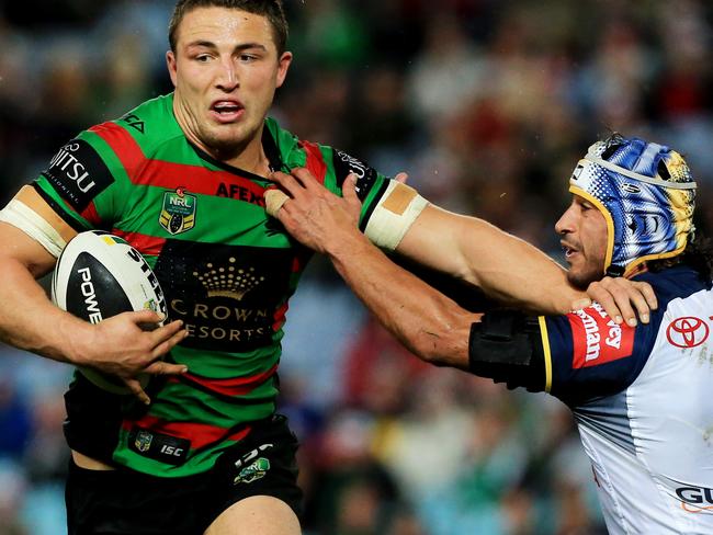 tackled by Johnathan Thurston Sam Burgess during the South Sydney Rabbitohs v North Queensland Cowboys round 24 NRL game at ANZ Stadium, Homebush. pic Mark Evans