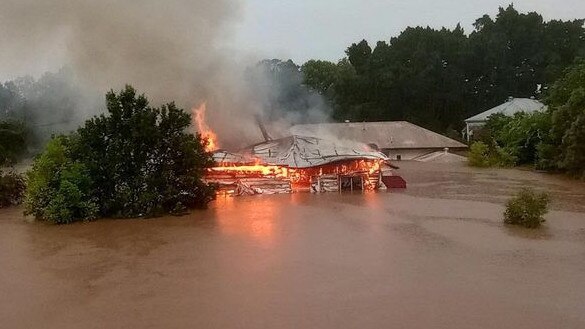 Rahima Jackson’s home in South Lismore burning during the floods in February 2022. Photo: Jennifer Steel.