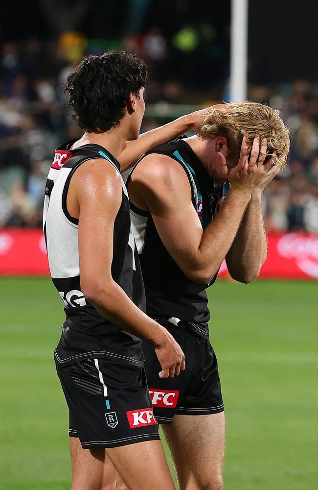 Jason Horne-Francis and Jase Burgoyne after the final siren on Thursday night. Picture: Sarah Reed/AFL Photos via Getty Images.