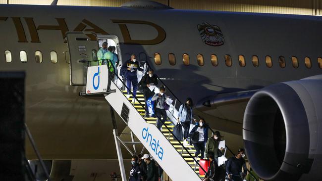 Tennis players and their support teams are seen disembarking Flight EY460 at Melbourne Jet Base adjoining the Melbourne International airport on January 14. Picture: Getty