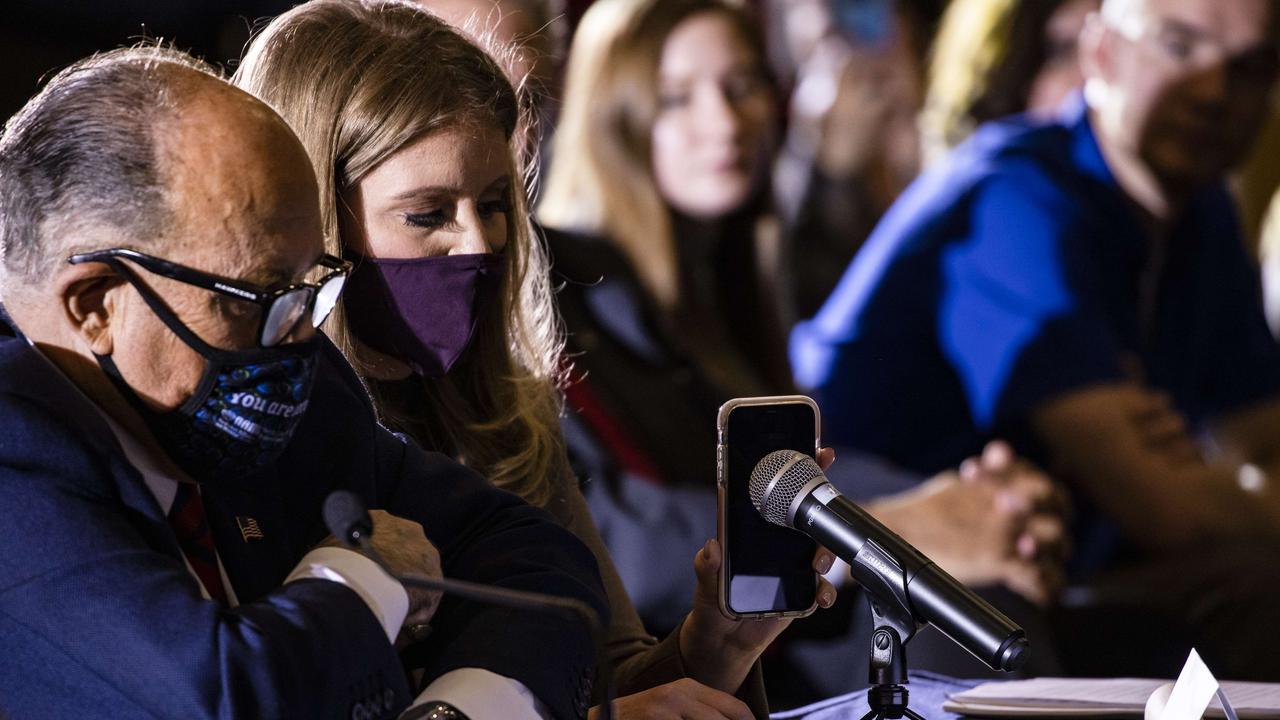 Mr Trump’s legal team during a public event last week. Jenna Ellis held her phone up to the microphone so the President could speak to his supporters. Picture: Samuel Corum/Getty Images/AFP