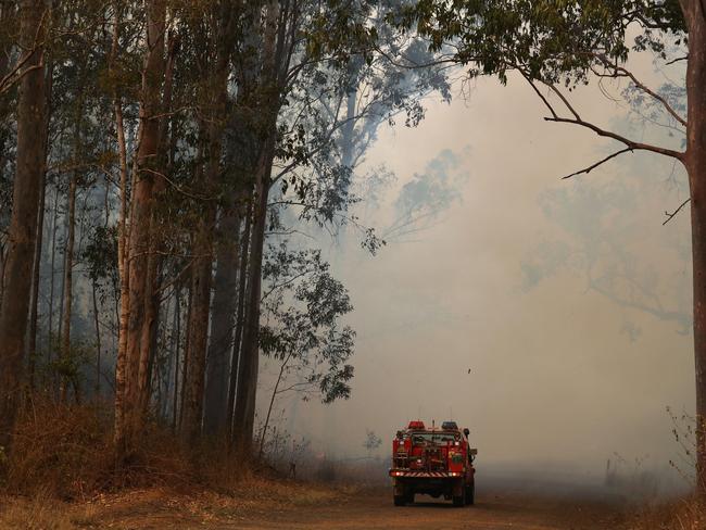 Firefighters battle bushfires in Busbys Flat, northern NSW, Wednesday, October 9, 2019. (AAP Image/Jason O'Brien)