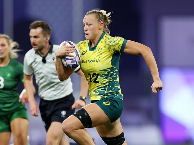 PARIS, FRANCE - JULY 29: Maddison Levi #12 of Team Australia breaks clear to score her team's third try during the Women's Rugby Sevens Quarter Final match between Team Ireland and Team Australia on day three of the Olympic Games Paris 2024 at Stade de France on July 29, 2024 in Paris, France. (Photo by Michael Steele/Getty Images)