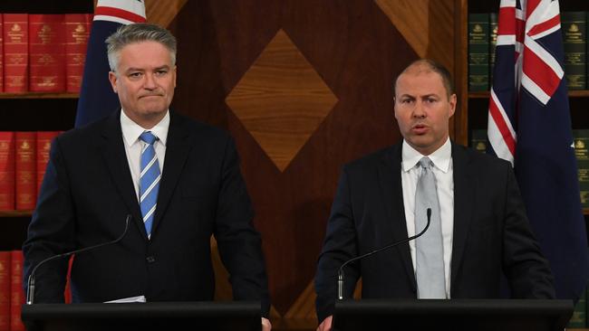 Finance Minister Mathias Cormann and Josh Frydenberg front the media in Melbourne yesterday. Picture: AAP