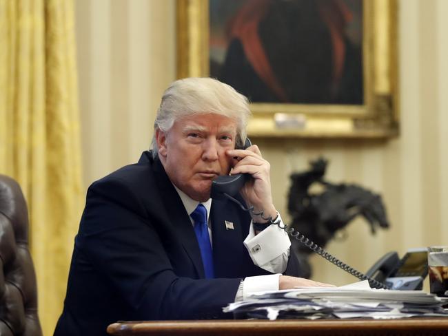 President Donald Trump speaking on the phone with Prime Minister of Australia Malcolm Turnbull in the Oval Office of the White House on Saturday. Picture: Alex Brandon/AP