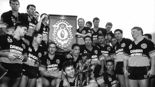 Captain Royce Simmons (front) with the Winfield Cup as he and his Penrith teammates celebrate the 1991 premiership.