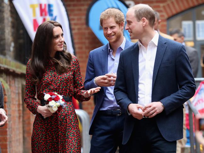 Christmas has always been family focused for the royals. Catherine, Duchess of Cambridge and Prince William, Duke of Cambridge with Prince Harry attend a Christmas party for volunteers in 2016. Picture: Getty Images