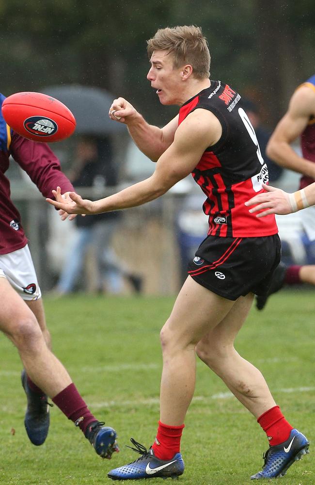 John Pritchard of Panton Hill handpasses during Saturday’s preliminary final. Picture: Hamish Blair.