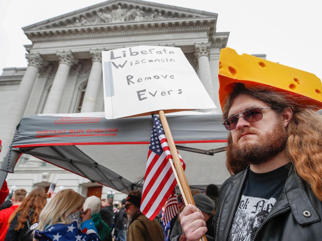 A man holds a sign demanding the Wisconsin governor’s removal during a protest on Friday in Madison. Picture: Kamil Krzaczynski