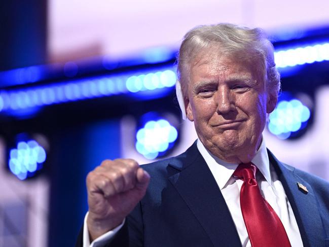 US former President and 2024 Republican presidential candidate Donald Trump holds up a fist onstage during the last day of the 2024 Republican National Convention at the Fiserv Forum in Milwaukee, Wisconsin, on July 18, 2024. Donald Trump will get a hero's welcome Thursday as he accepts the Republican Party's nomination to run for US president in a speech capping a convention dominated by the recent attempt on his life. (Photo by Brendan SMIALOWSKI / AFP)