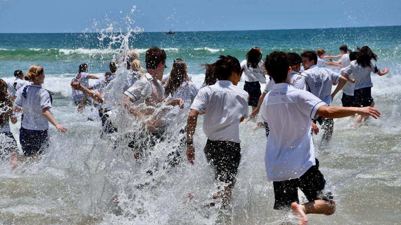 Year 12 graduates from schools across the Sunshine Coast hit to the water at Mooloolaba Beach to celebrate the end of their schooling. Photo: Mark Furler