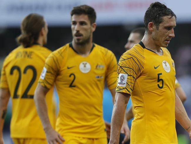 Australia's midfielder Mark Milligan, right, leaves the pitch with teammates at the end of the AFC Asian Cup group B soccer match between Australia and Jordan at Hazza bin Zayed stadium in Al Ain, United Arab Emirates, Sunday, Jan. 6, 2019. Jordan won 1-0. (AP Photo/Hassan Ammar)