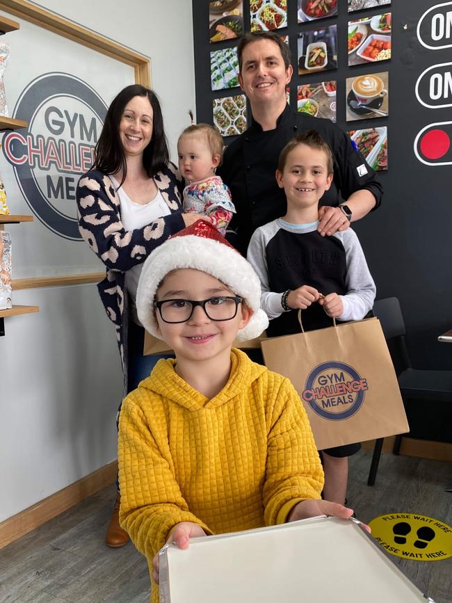 Kylie and Alex Marlow from Gym Challenge Meals with their children. Picture: Gym Challenge Meals