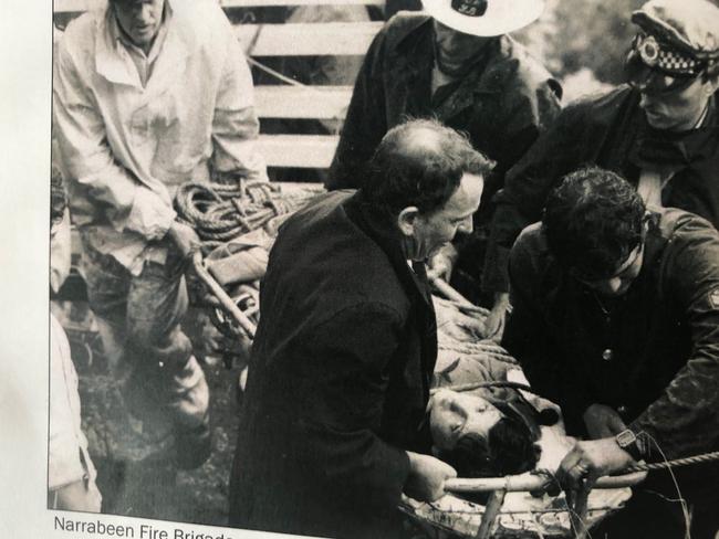 Firefighters from the Narrabeen brigade used their local knowledge to locate a boy trapped in a flooded creek after he had been washed 750m down a stormwater drain at Collaroy Plateau in March 1983. Picture: Museum of Fire Collection