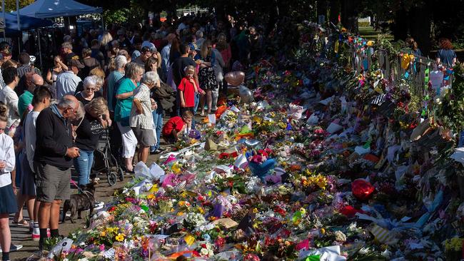 Floral tributes to those who were gunned down at the two mosques are seen against a wall bordering the Botanical Garden in Christchurch. Picture: AFP 