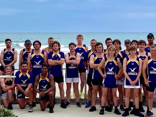 The Port Fairy squad pose for a photo before the Christmas break at a beach in the town. Picture: Port Fairy Football Club.