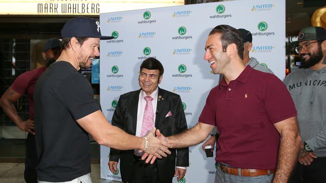 Hollywood star Mark Wahlberg shaking hands with northern entertainment entrepreneur Sam Mustaca from United Cinemas as Sam’s father Roy Mustaca looks on. Hollywood star Mark Wahlberg was Sydney in december 2020 to to sign the deal with the Mustacas to bring his chain of Wahlburgers restaurants to Australia. Picture: Chris Khoury