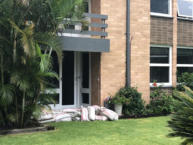 Residents of an apartment block in Robertson St, Narrabeen, on the eastern side of Narrabeen Lagoon, sandbagged the entrance on Wednesday ahead of an expected East Coast Low rain deluge. Picture: Jim O'Rourke