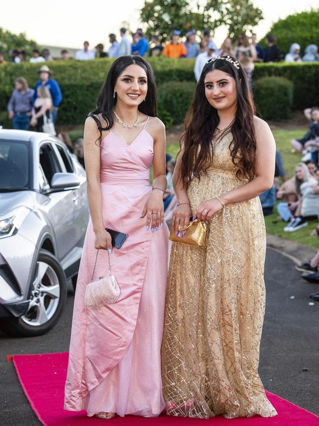 Falak Zghla (left) and Ghalya Zindinan arrive at Harristown State High School formal at Highfields Cultural Centre, Friday, November 18, 2022. Picture: Kevin Farmer