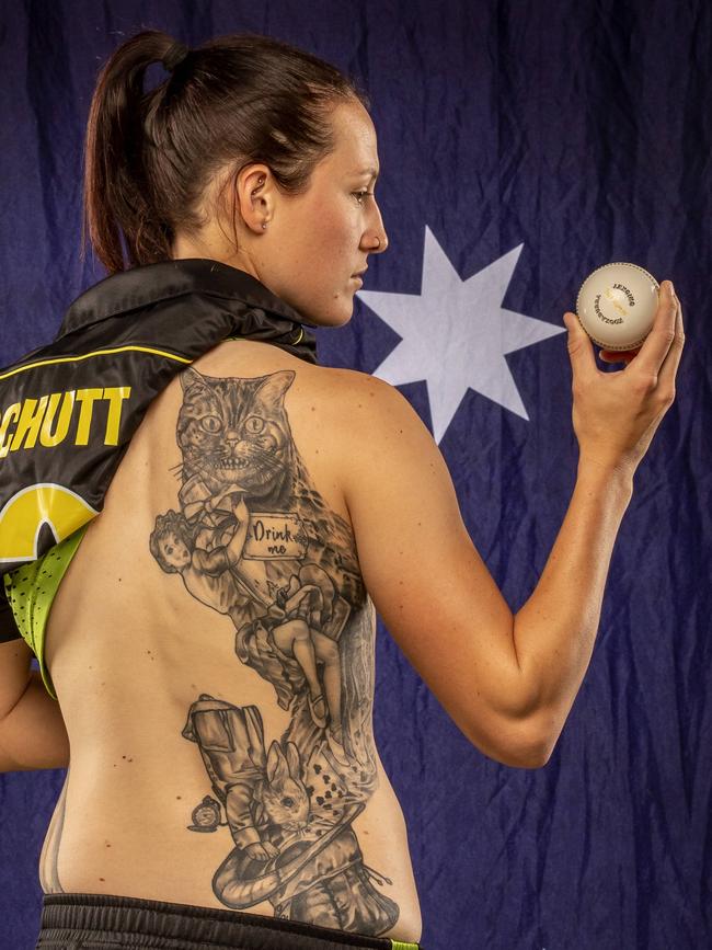 Australian bowler Megan Schutt shows off her large tattoo depicting the story of Alice in Wonderland. Picture: TIM CARRAFA