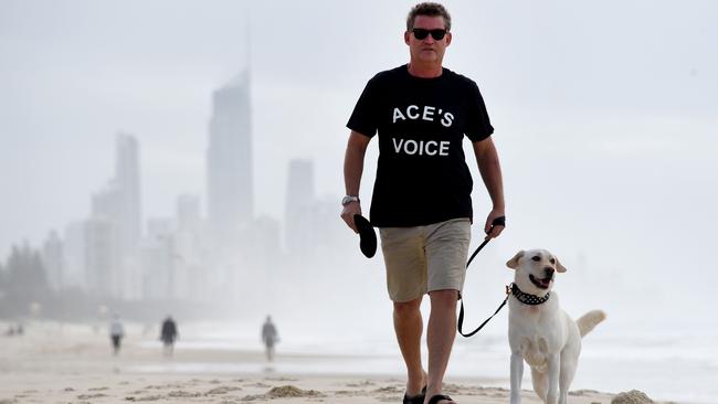 Gold Coast dog owner Phillip Deed on his regular walk with dog Ace at Miami Beach. Photo: Steve Holland