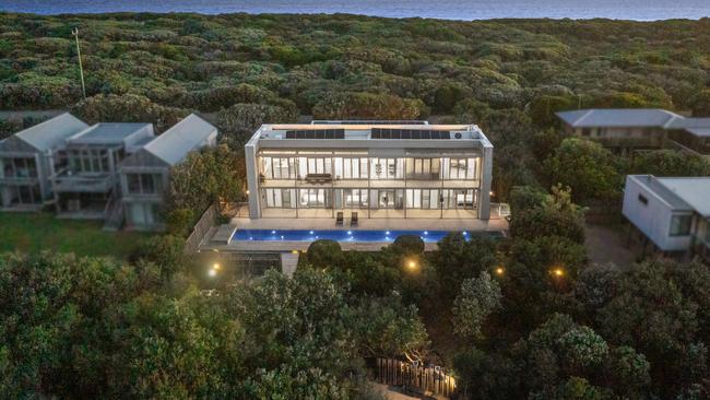 A lap pool runs the length of the house, with native gardens beyond.