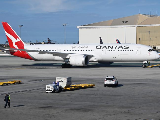 (FILES) In this file photo a Boeing 787-9 Dreamliner from Qantas Air Lines is seen on the tarmac of LAX Los Angeles airport on May 11, 2019. - Boeing will consolidate manufacturing of the 787 Dreamliner plane to one plant in the US, ending production of the wide-body jet in Washington state, the company announced on October 1, 2020. The move follows earlier announcements by Boeing that it would slash production of the jets to six per month in 2021 from 14 due to weak demand for airline travel because of the coronavirus. (Photo by Daniel SLIM / AFP)