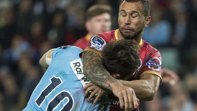 Quade Cooper nearly decapitates Bernard Foley. Picture: Mitch Cameron