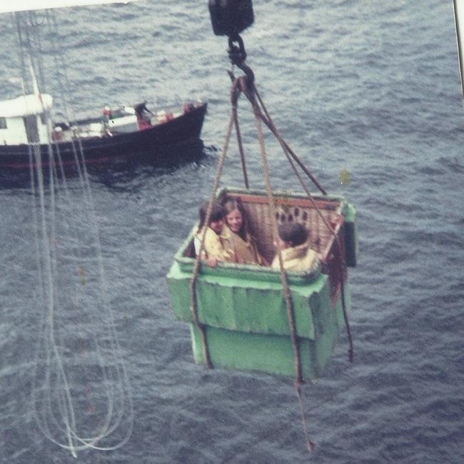 Jackson sisters Lena, Carol and Dee coming home for holidays in 1972, in the flying fox basket being winched up to the landing on the island. Supplied by Carol Jackson.