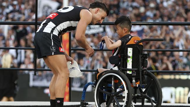 Nick Daicos receives his premiership medal from James Nguyen. Photo by Michael Klein