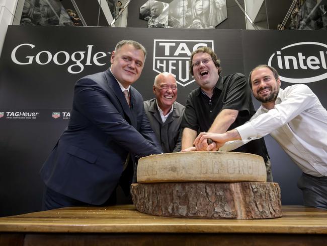 (L TO R) Swiss watchmaker Tag Heuer Director General Guy Semon, Tag Heuer CEO Jean-Claude Biver, Intel's new device general manager Michael Bell and Google's engineering director for Android wear David Singleton pose with a Swiss cheese during the anoucement on March 19, 2015 in Basel of a partnership between the watch brand, owned by the French luxury group LVMH and the two giants of the Silicon Valley. Luxury Swiss watchmaker Tag Heuer announced it was joining forces with technology behemoths Google and Intel to develop a connected timepiece that can compete with the new Apple Watch.AFP PHOTO / FABRICE COFFRINI