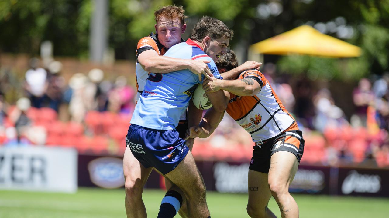 Brock Patti of Western Clydesdales is tackled by Carina Brisbane Tigers players in pre-season Host Plus rugby league at Toowoomba Sports Ground, Sunday, February 16, 2025. Picture: Kevin Farmer