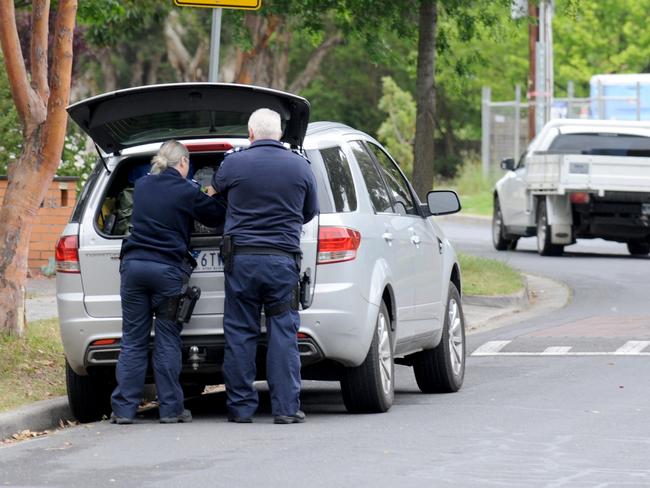 Officers outside the Templestowe home of Mr Bailey. Picture: Andrew Henshaw