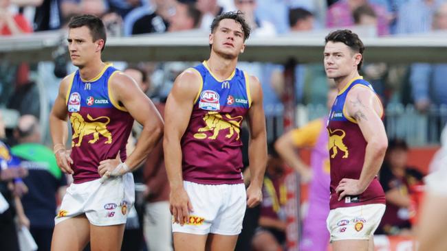 Hugh McCluggage, Cam Rayner and Lachie Neale after the final siren on grand final day. Picture Lachie Millard