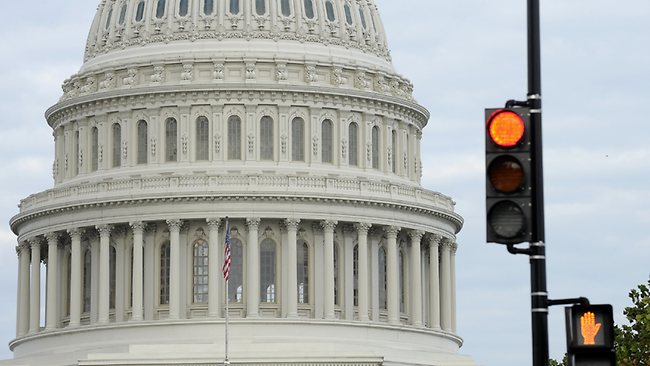 A stop light flashes near the Capitol in Washington.