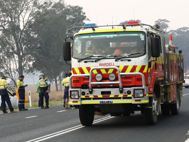 A roadblock due to bushfires near Busbys Flat, northern NSW, Wednesday, October 9, 2019. Fire warnings are in place across parts of northern NSW as out-of-control blazes continue to burn. Up to 30 homes have been lost as bushfires ravaged parts of northern NSW on Tuesday, with the village of Rappville particularly affected. (AAP Image/Jason O'Brien)