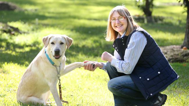 Lillian Eastlake-Smith has been raising puppies for Guide Dogs Australia for 14 years and has been nominated for a Pride of Australia Award. Pic of her with her puppy Lacey at Glossodia. Photo: Bob Barker.