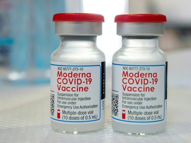 (FILES) In this file photo taken on April 20, 2021 Moderna vials sit on a table before they are loaded into syringes at a mobile Covid-19 vaccination clinic in Bridgeport, Connecticut. - A new study released by the US Centers for Disease Control and Prevention (CDC) on September 17, 2021, is the latest to suggest the Moderna Covid vaccine confers better long-term protection against hospitalization than Pfizer. CDC researchers conducted an analysis of nearly 3,689 adults who were hospitalized with severe Covid from March 11 to August 15, 2021 -- a period that precedes and includes the dominance of the Delta variant. (Photo by Joseph Prezioso / AFP)