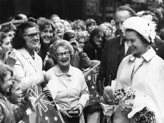 Queen Elizabeth II stops to talk to a group of children on her Rundle Mall walk.